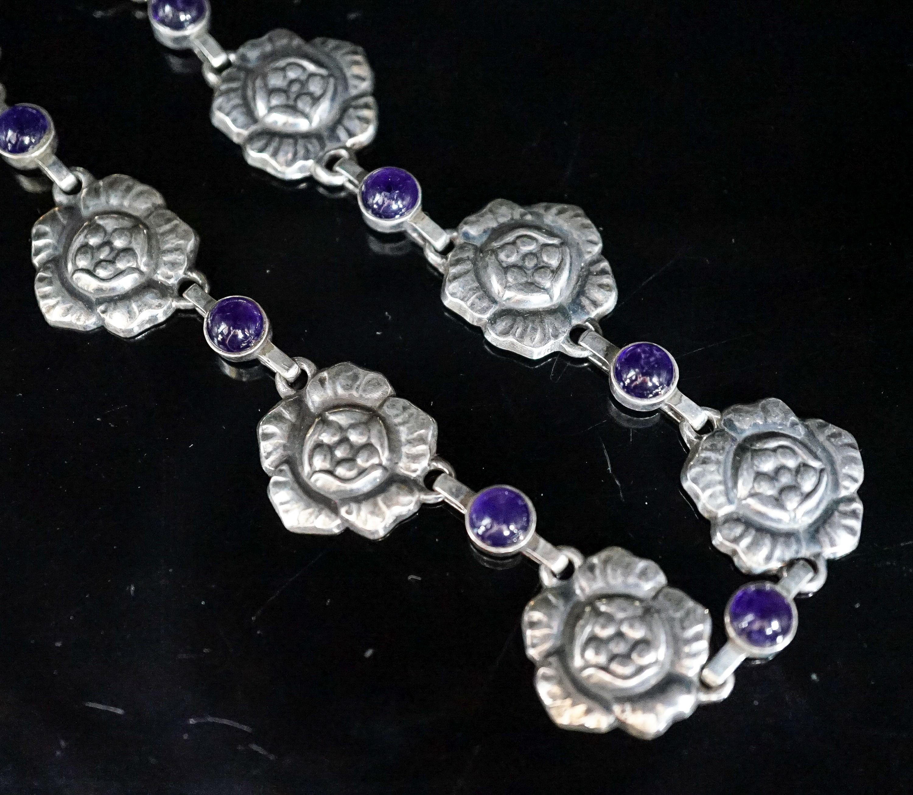 A Georg Jensen sterling flower head and cabochon amethyst link necklace, set with twelve stones. no. 5, approx. 42cm.
